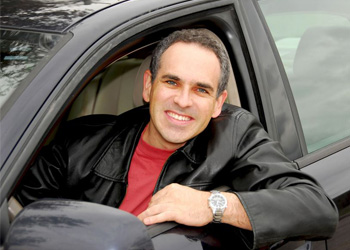 Virginia driver looking out of his car window smiling